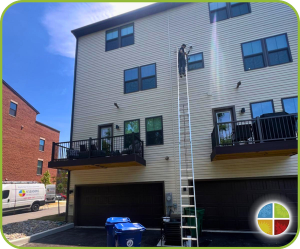 Image of a worker on a ladder cleaning the vents