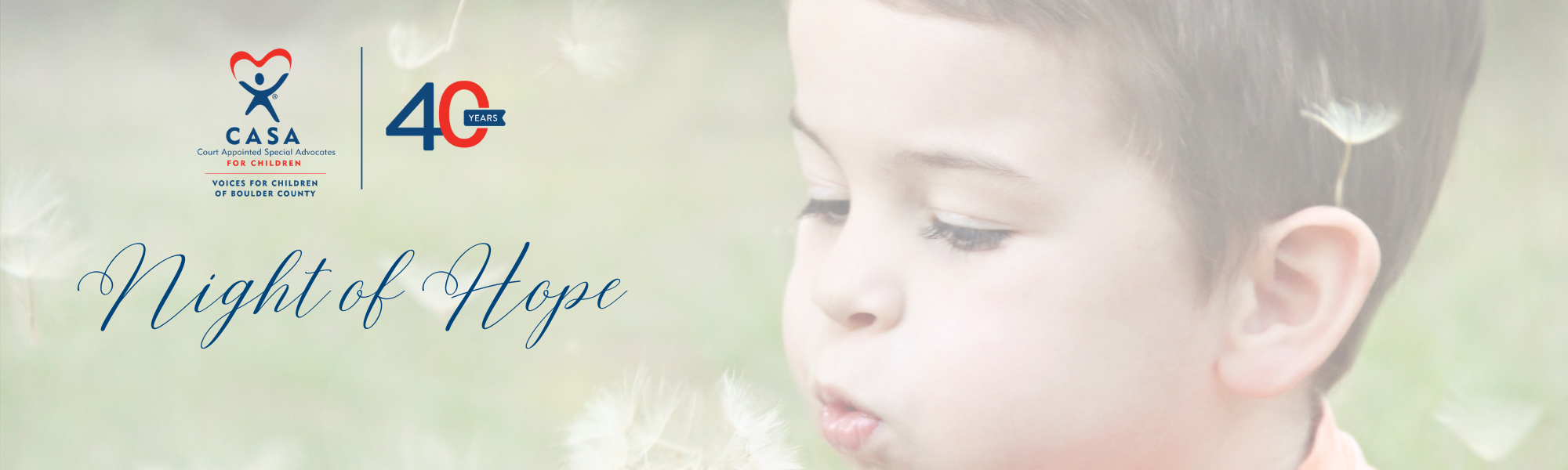 boy blowing a dandelion