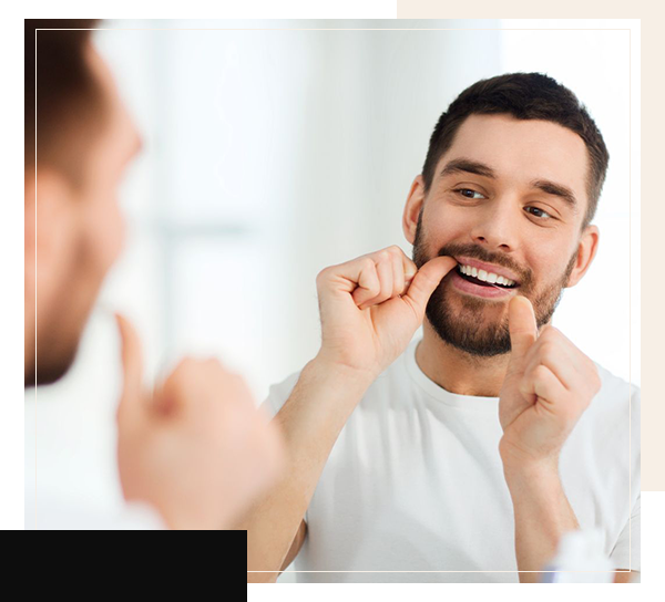 Man flossing his teeth