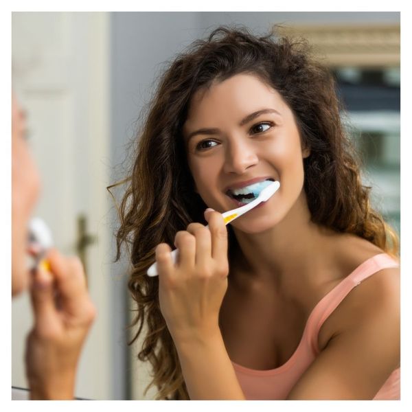 woman brushing teeth