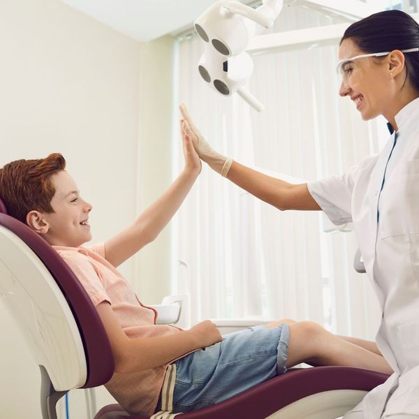 Kid giving a dentist a high five