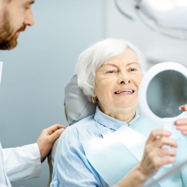 elderly woman receiving dental implants
