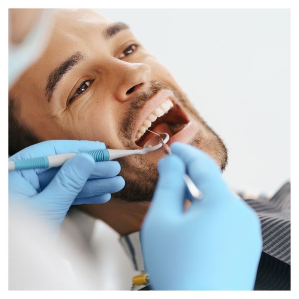 dentist looking at mans teeth