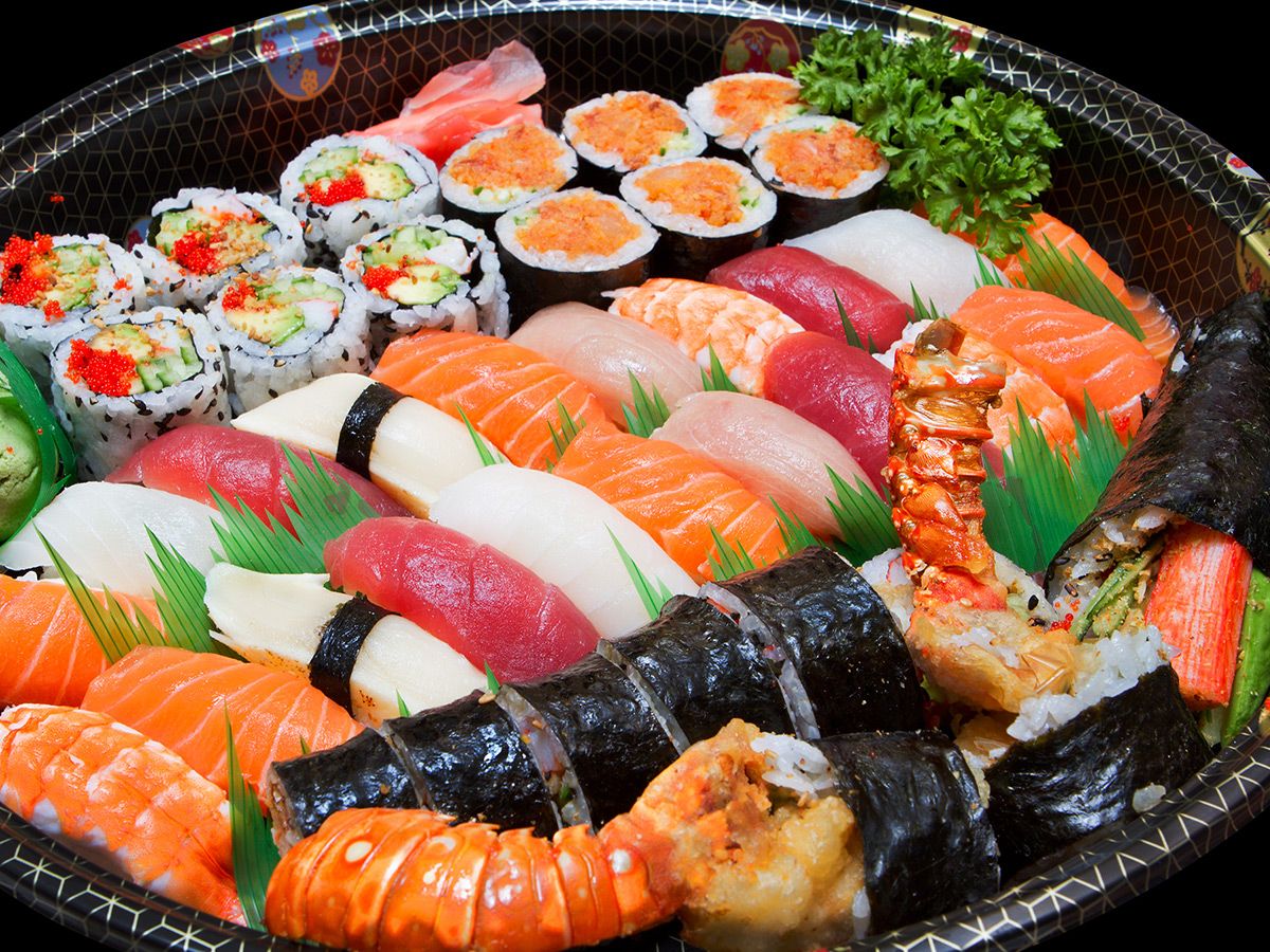 Large tray filled with various types of sushi including rolls, nigiri, and so on.
