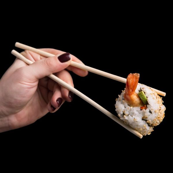 sushi held with chopsticks