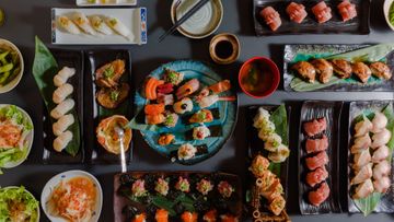 A table full of Japanese Sushi