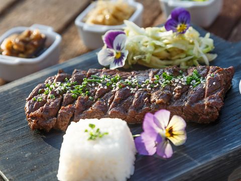 Plate of Japanese cuisine including steak, rice, and garnishes