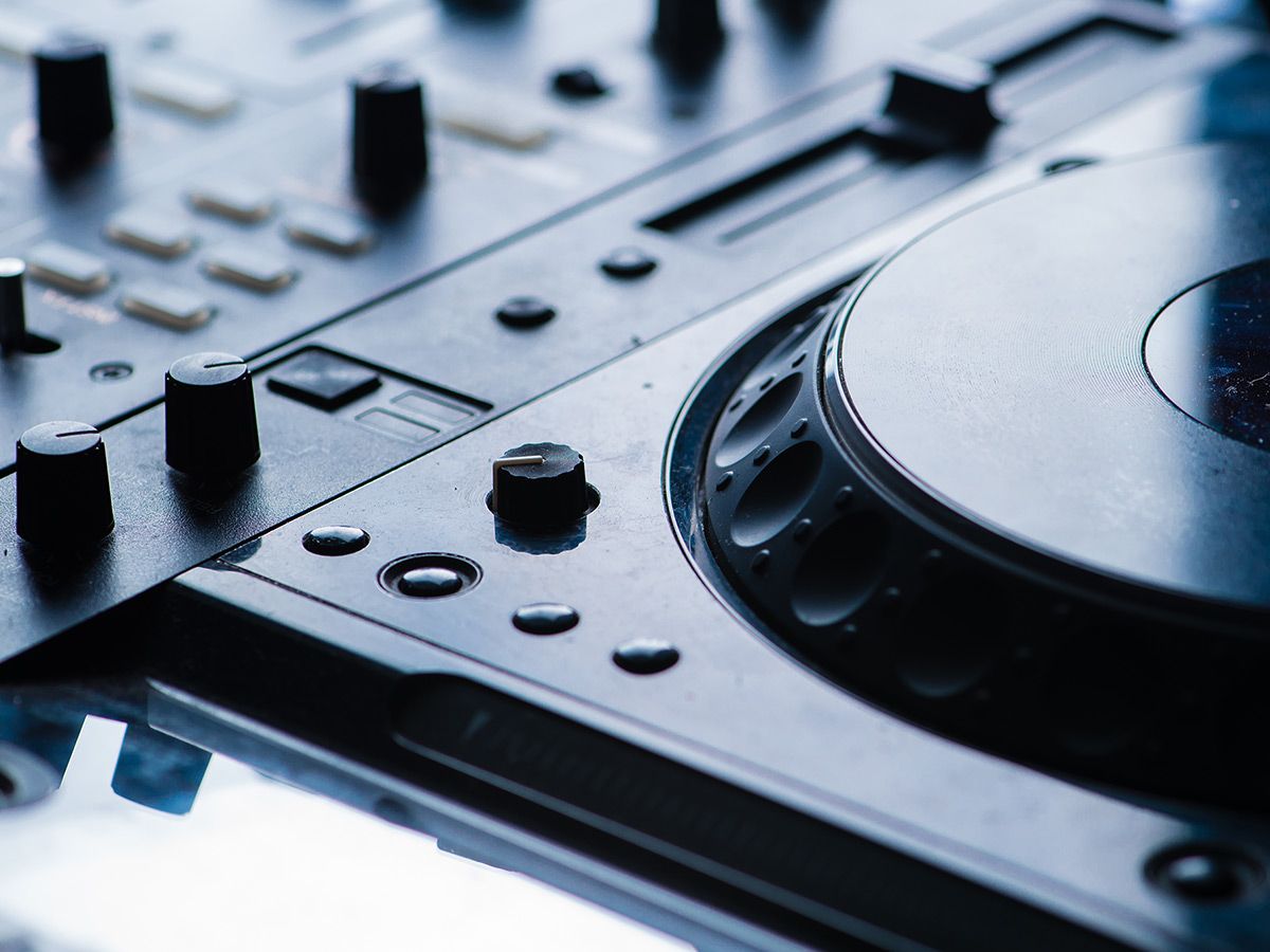 Black and white shot of a shadowed DJ turntable