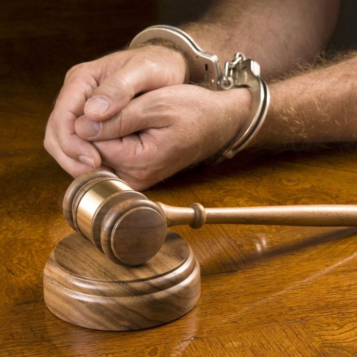 person in handcuffs in court
