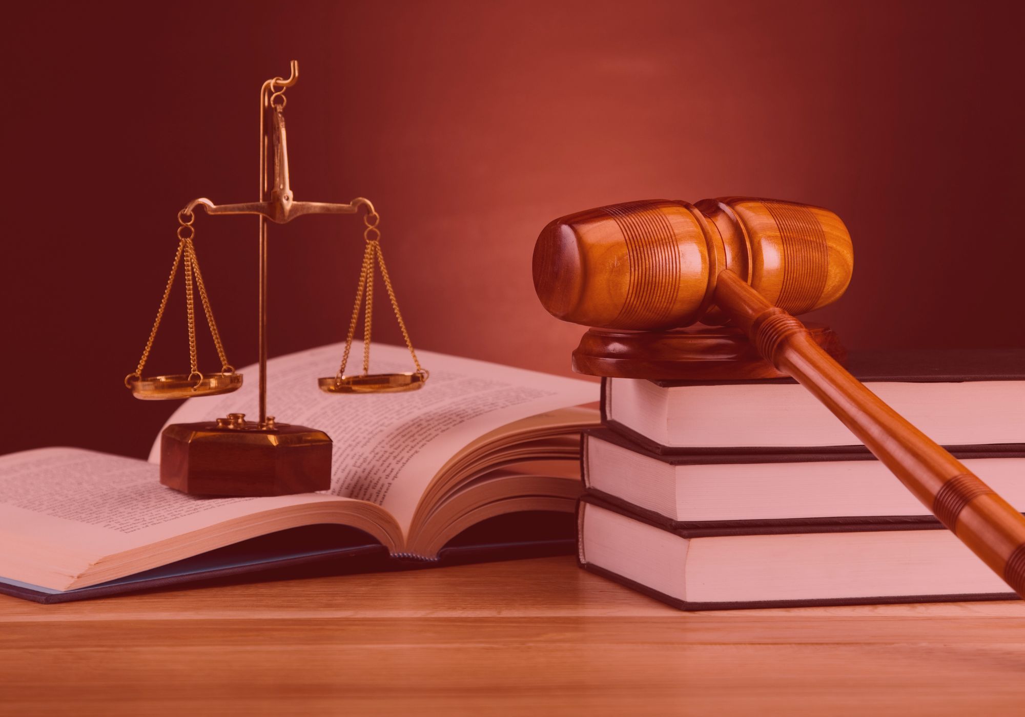 a gavel, scale of justice, and books on a table