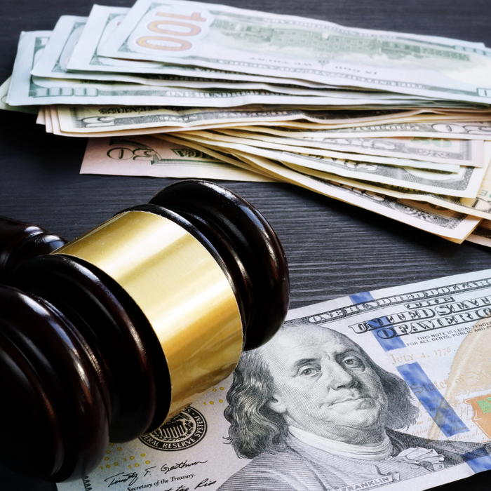 a gavel with money, representing a bail bond How to Conduct a Miami Dade Inmate Search3.png