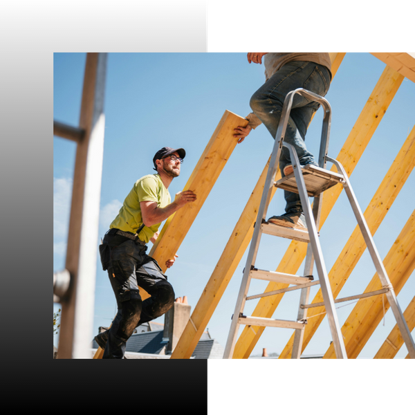 roofers building roof with wood planks