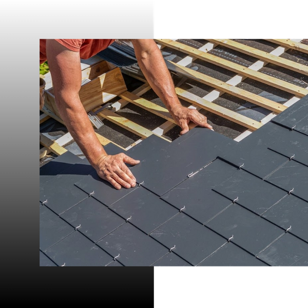 roofer placing roofing material on roof