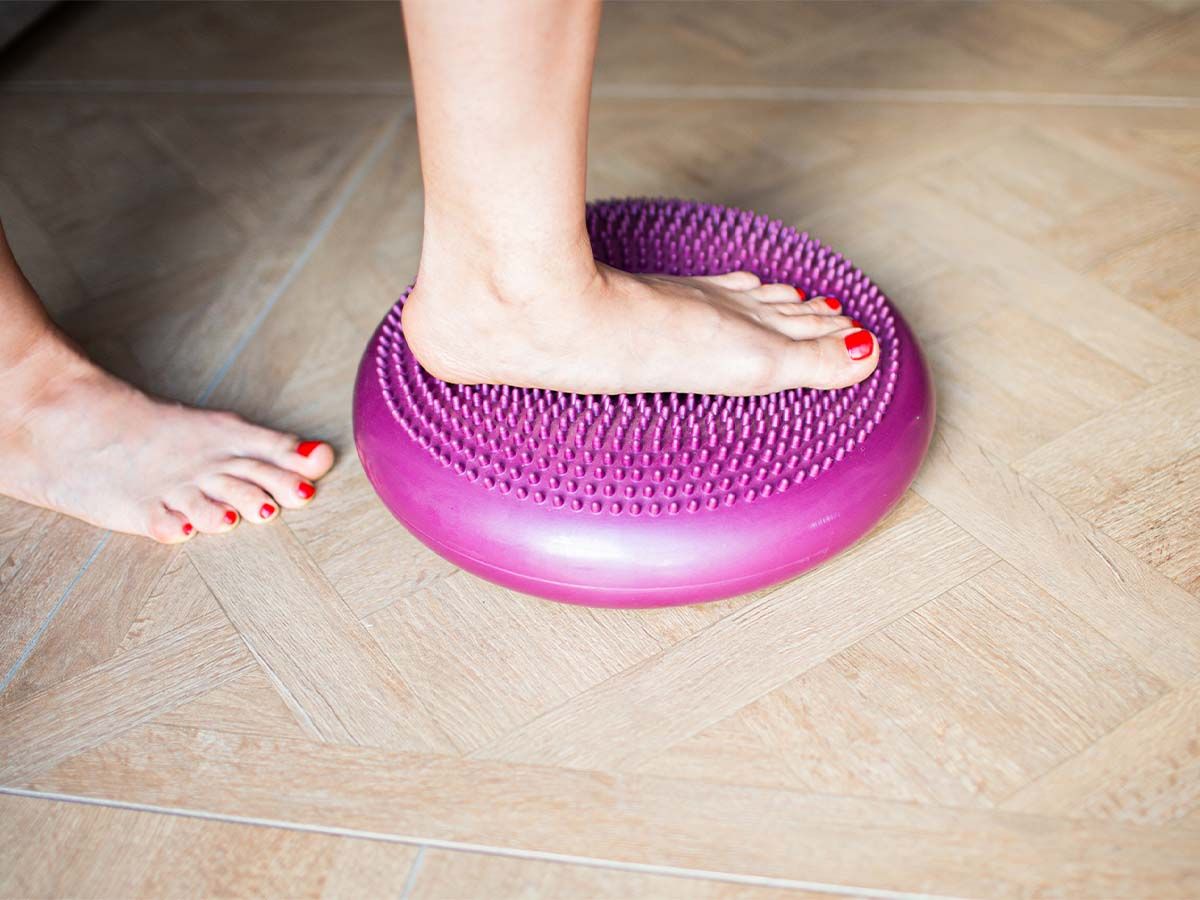 An image of a woman stepping on an inflatable disk.