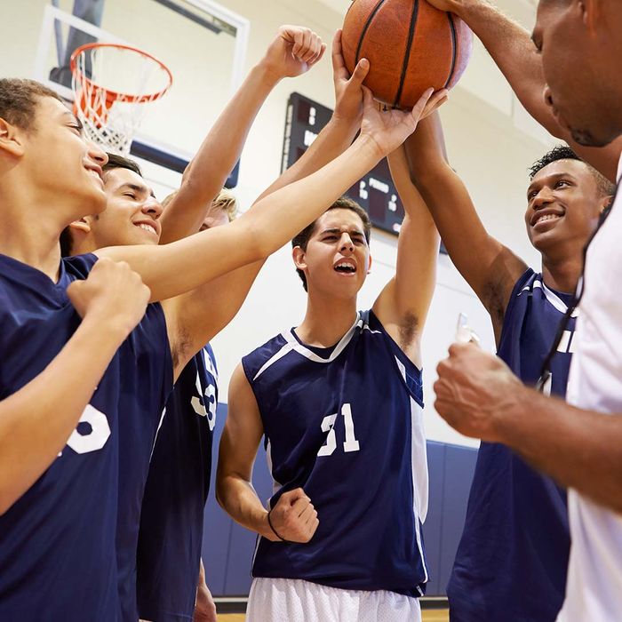 Boys cheering during huddle at basketball game