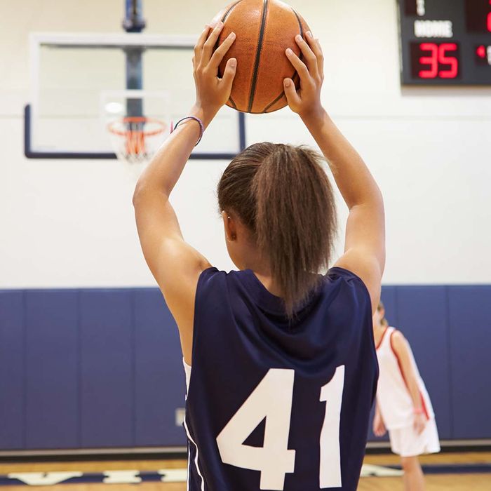 Girl aiming at a hoop with a basketball