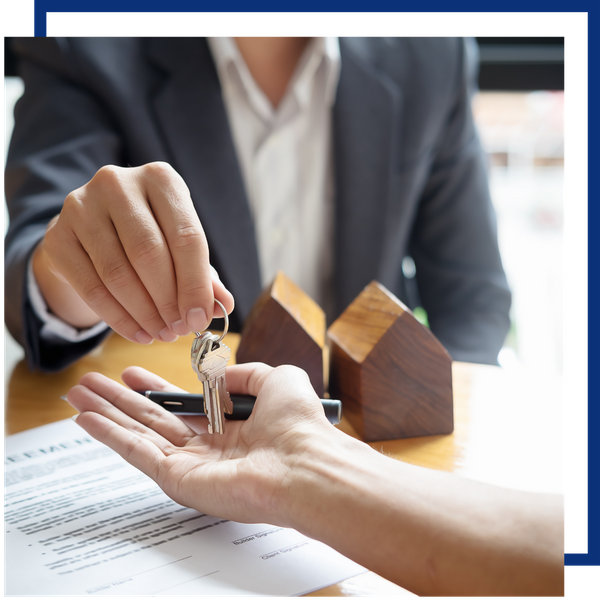 real estate agent handing keys to buyer