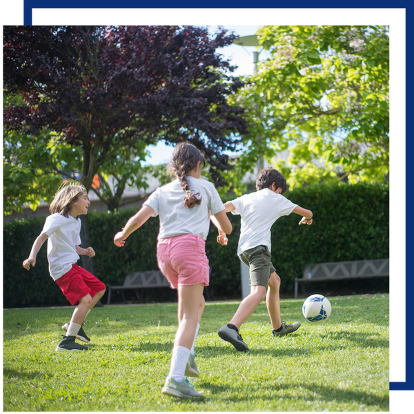kids playing soccer at a park kids playing soccer at a park