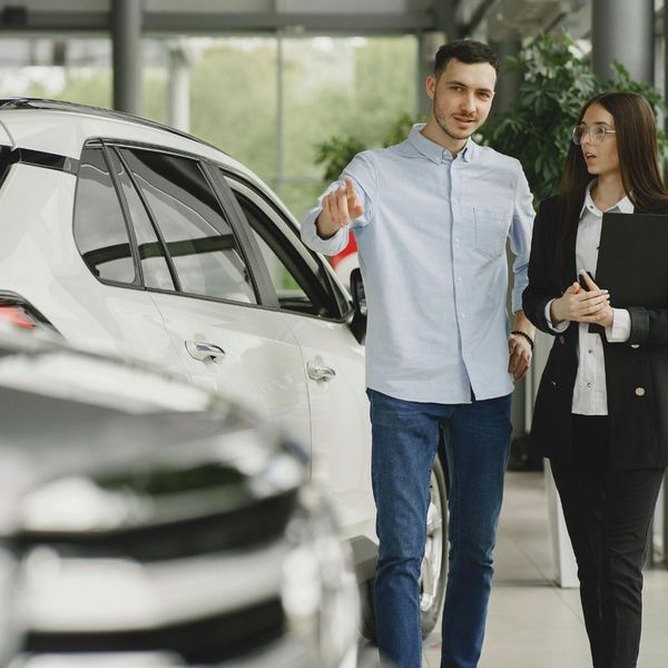 man speaking with dealer at dealership man speaking with dealer at dealership