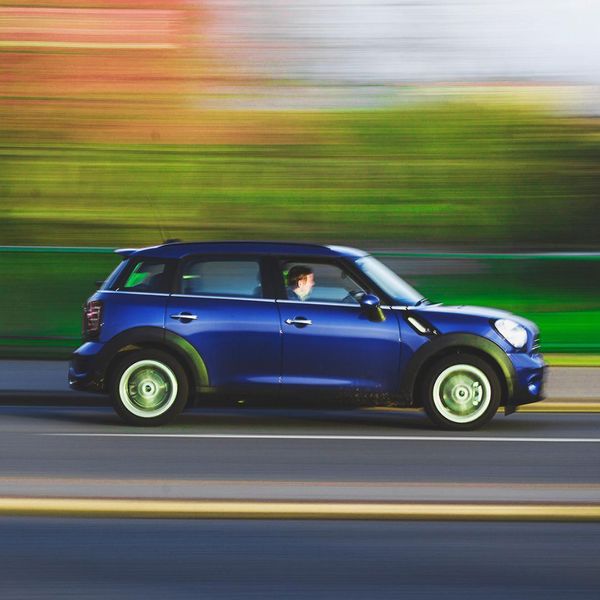 blue car driving on road blue car driving on road
