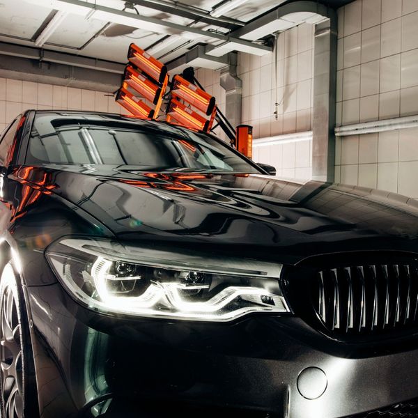 black car under orange lighting black car under orange lighting