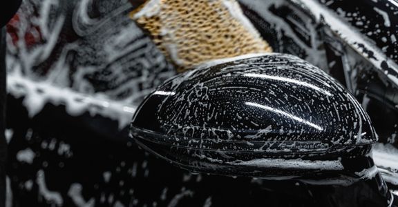 A professionally detailed luxury black car, showcasing the high-quality results of auto detailing services.