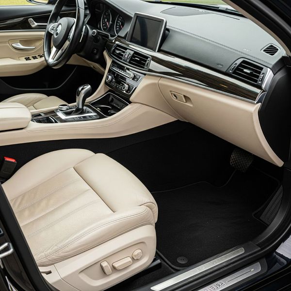 The clean interior of a car, showing pristine carpets and leather upholstery. The clean interior of a car, showing pristine carpets and leather upholstery.