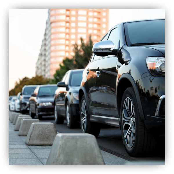 Tinted cars parked on the side of the road