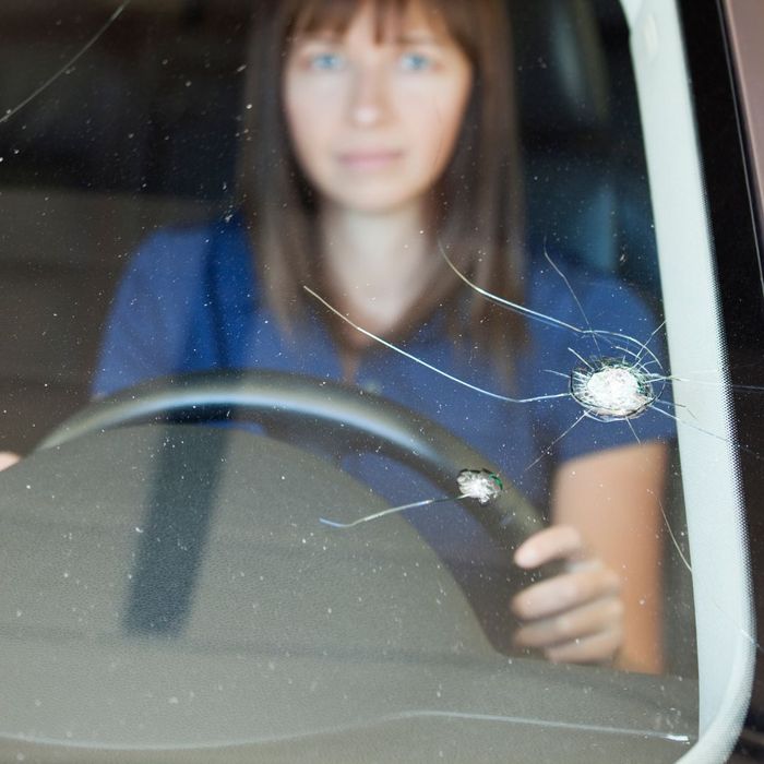 woman in car with cracked windshield