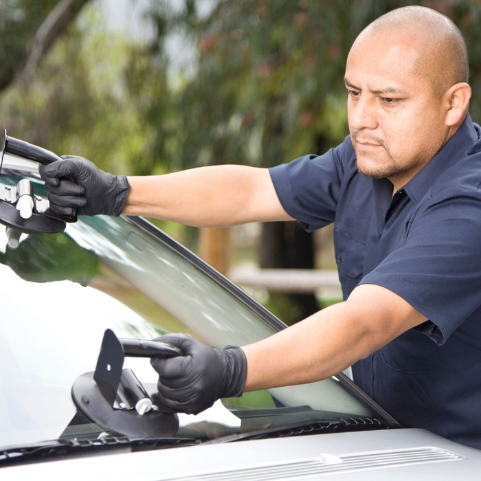 person replacing windshield 