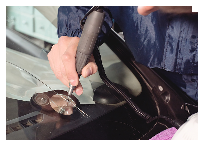 technician repairing windshield