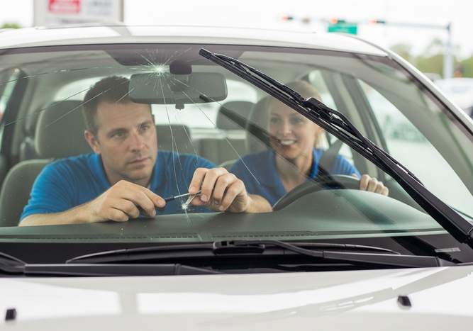 Man Repairing Car Windshield