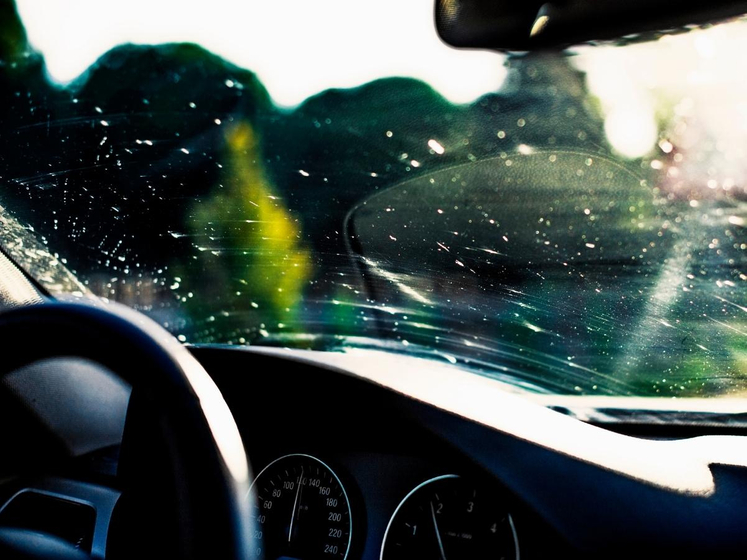 Scratched and pitted car window Scratched and pitted car window