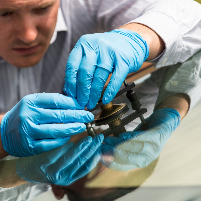 man inspecting windshield chip