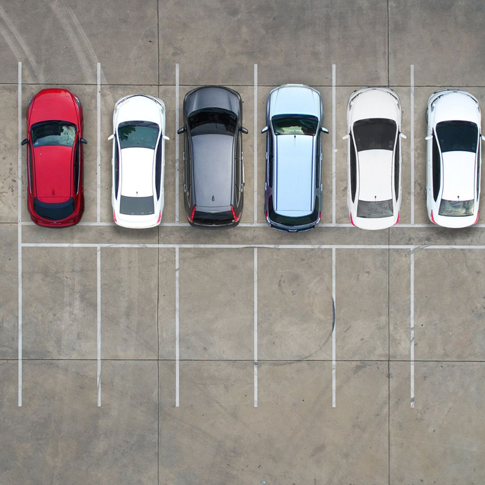 aerial view of cars parked in a parking lot 1080x1080-AutoGlassRepairPrevention1.jpg