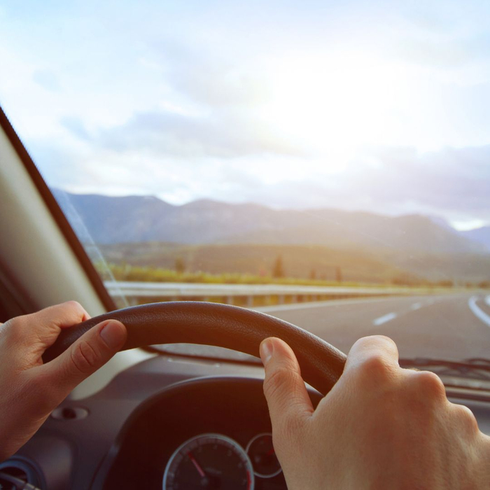 man driving down the road towards the mountains