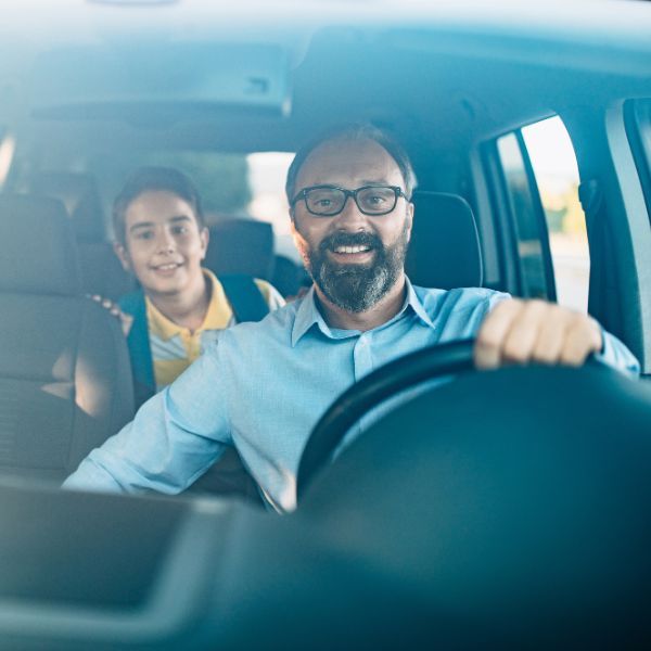 father and son driving in car