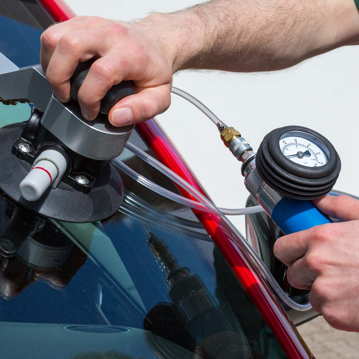 Mobile auto glass tech fixing a crack Mobile auto glass tech fixing a crack