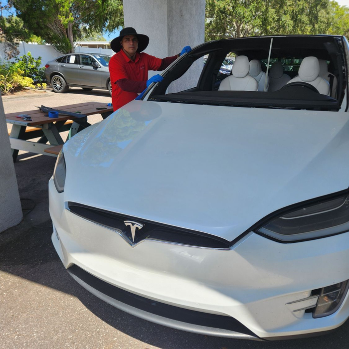 Prestige technician replacing Tesla windshield Prestige technician replacing Tesla windshield