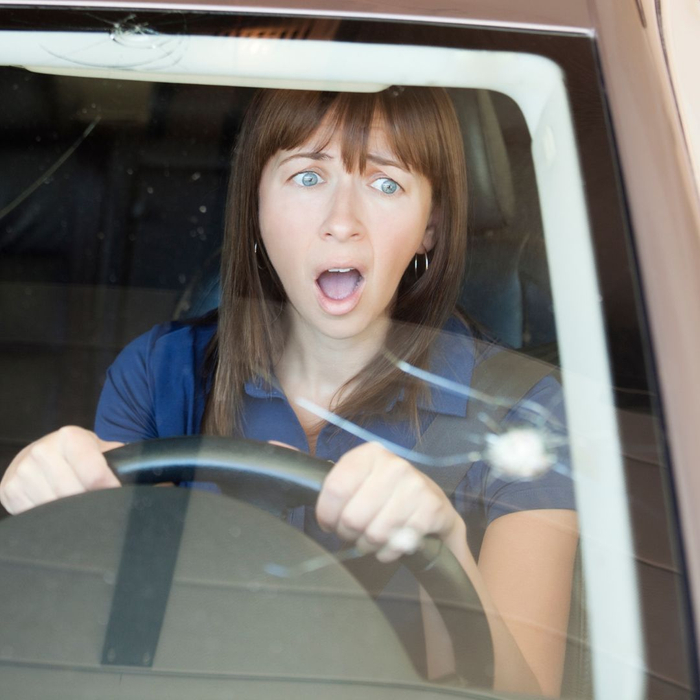 shocked woman with large windshield chips