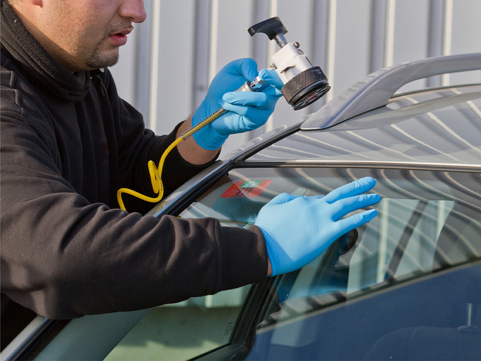 Man fixing window crack Man fixing window crack
