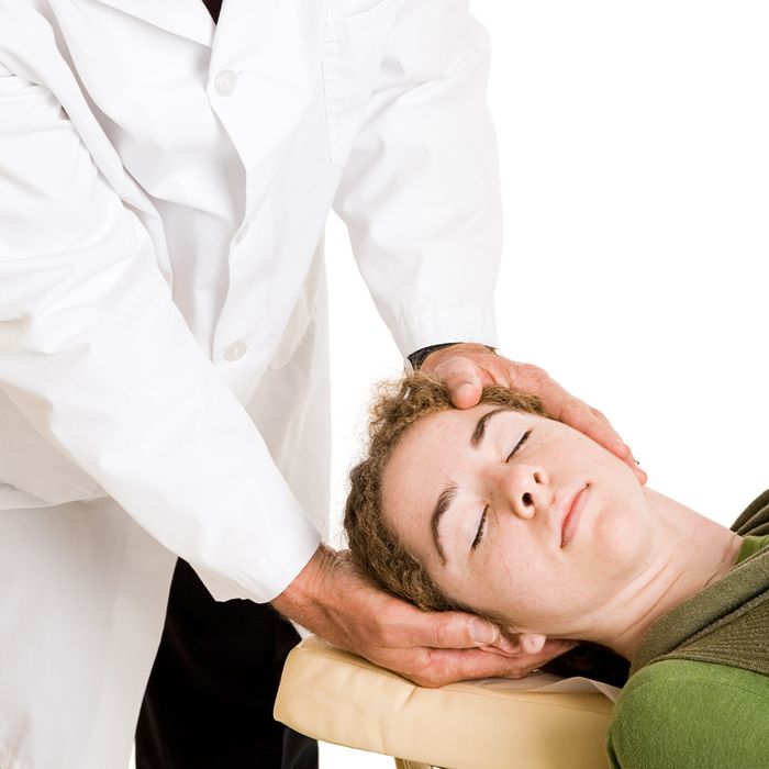 a chiropractor about to realign a patients neck