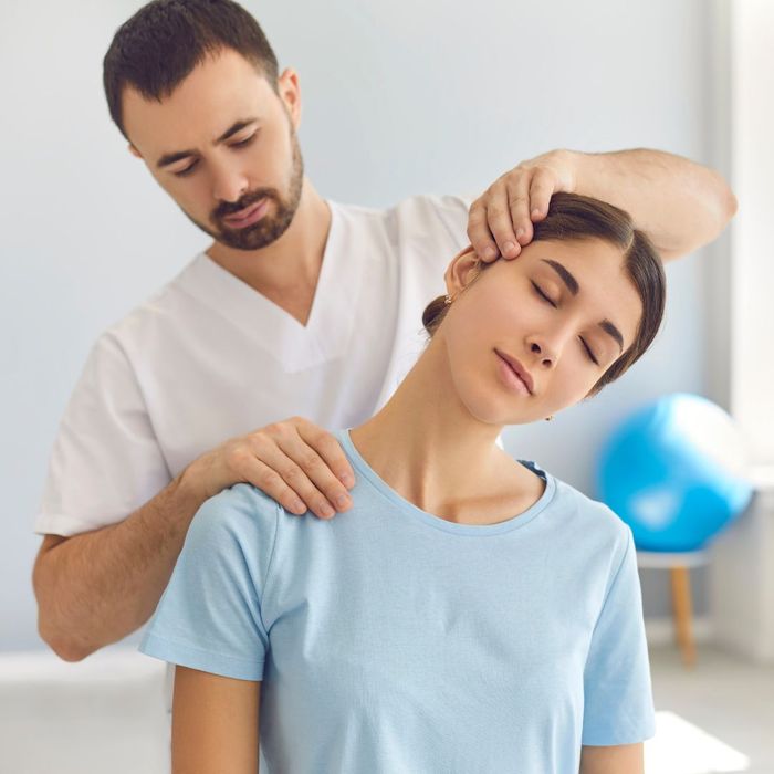 Woman getting her neck adjusted by a chiropractor.