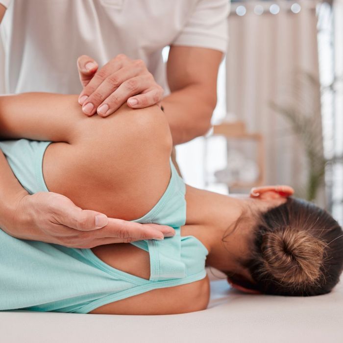 woman getting adjusted by a chiropractor. 