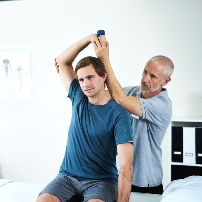 Chiropractor working on range of motion with a male patient. 
