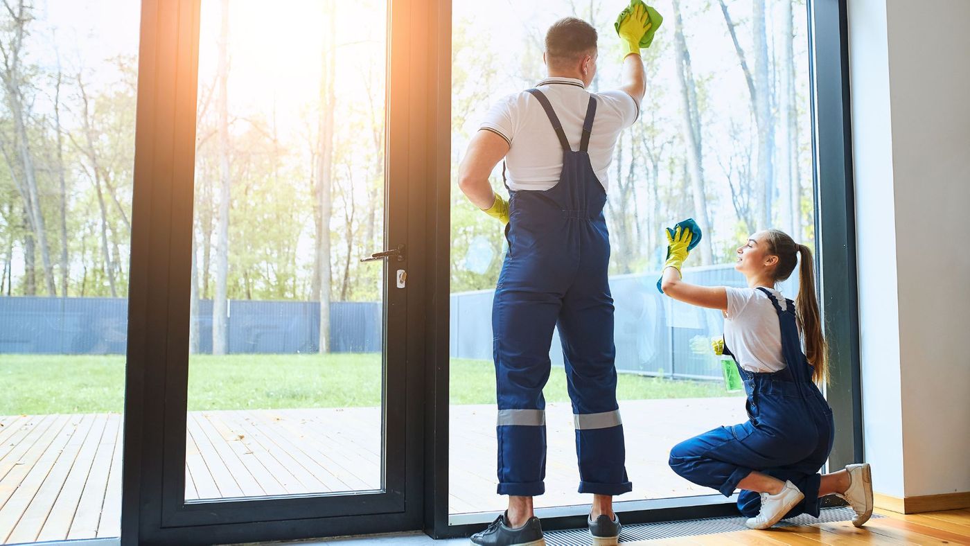 professional cleaners cleaning large door window