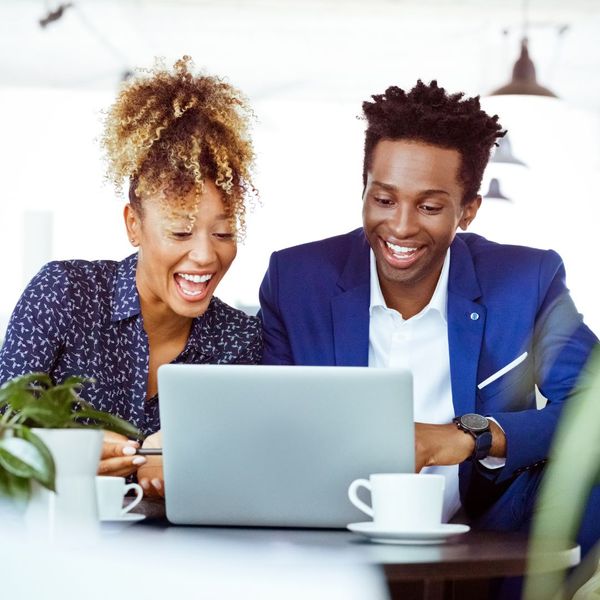 Young couple happy and looking at laptop