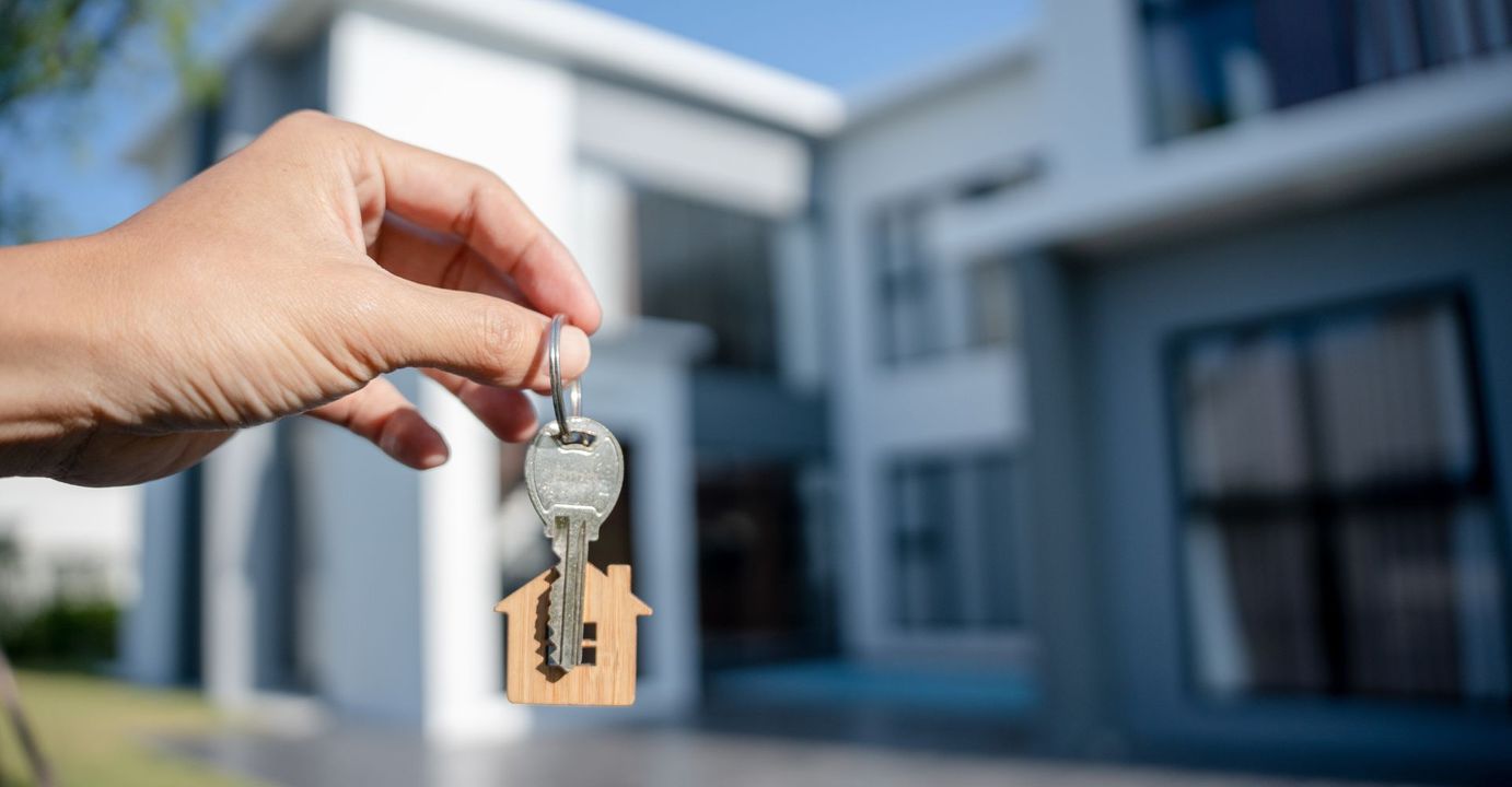 Close-up of house keys in front of a home