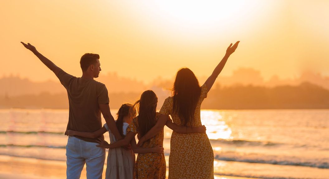 Family looking at a sunset on the beach