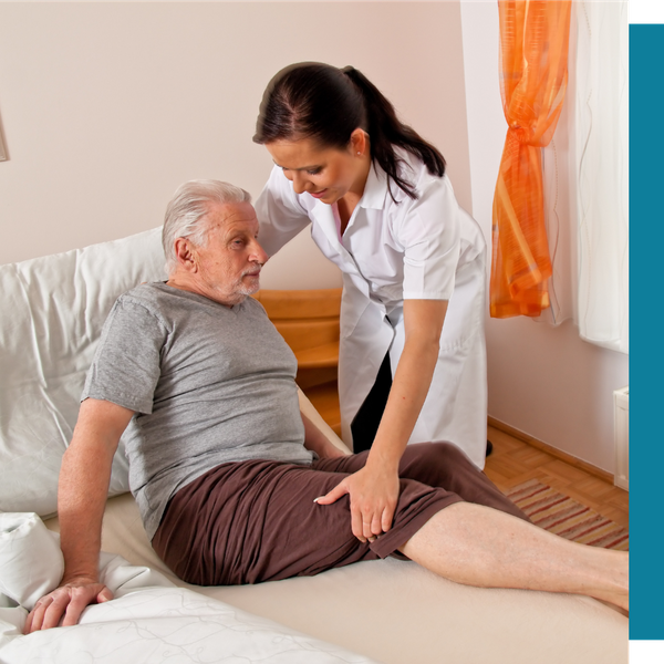caregiver helping older man out of bed
